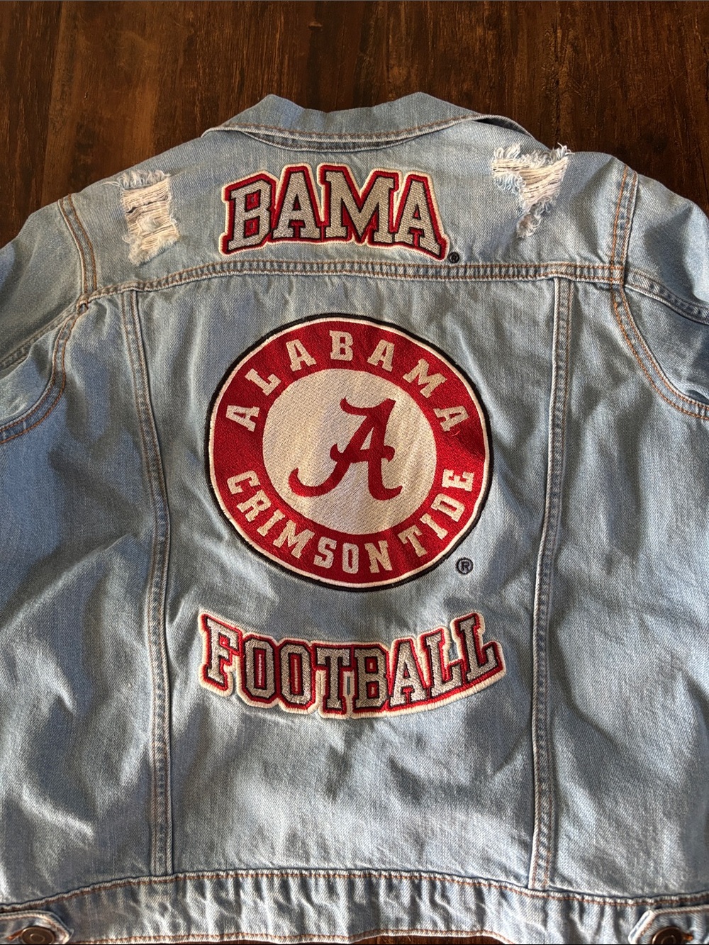 Alabama Crimson Tide women's light-wash denim jacket featuring embroidered